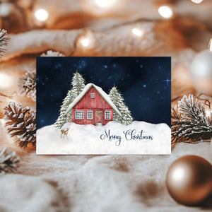 Christmas card with a red cabin in the snow, surrounded by festive decorations.